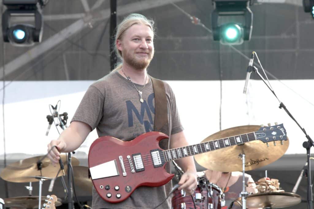 Guitarist Derek Trucks is shown performing on stage during a "live" concert with Tedeschi & Trucks.